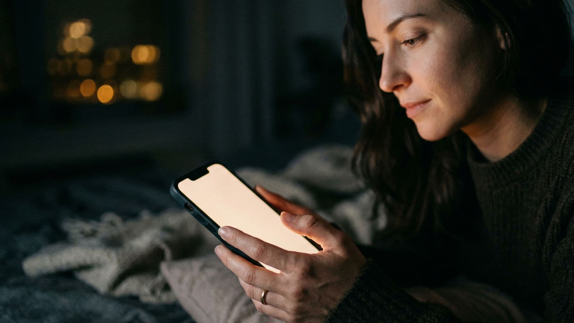 Woman chatting on her phone at night